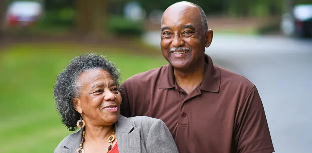 Smiling senior couple standing together outdoors