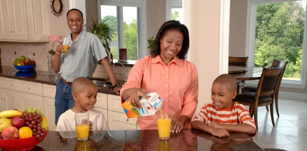 Family preparing breakfast together in their kitchen